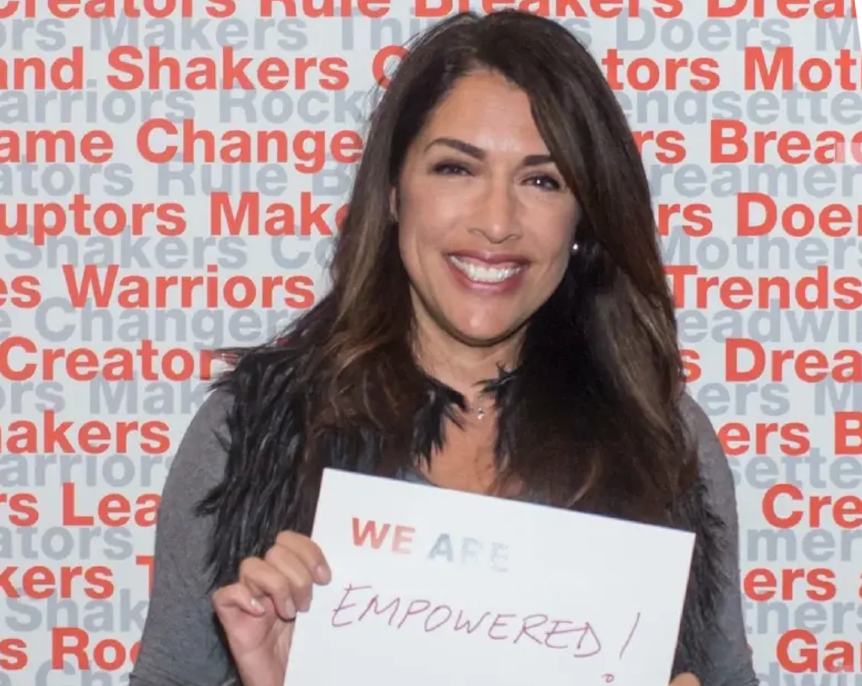 Empowerment sign held by smiling woman