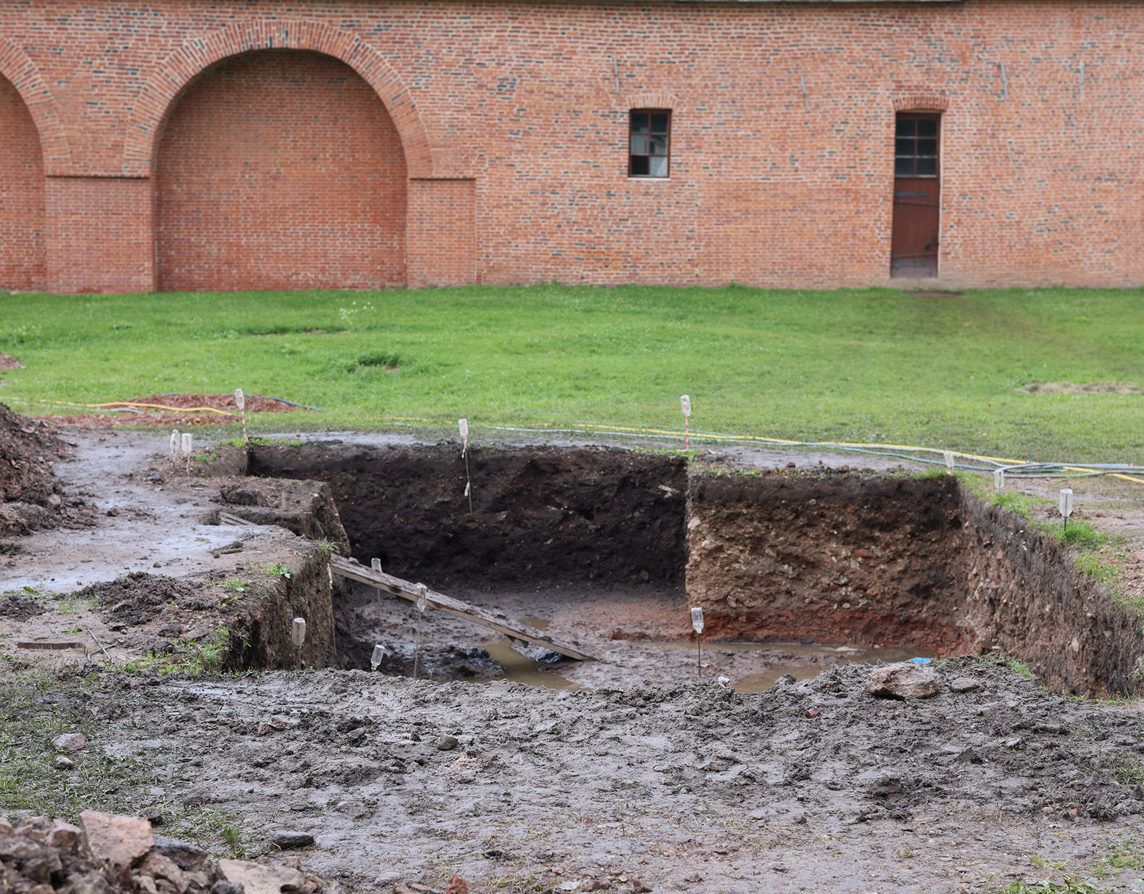 Archaeological excavation near brick structure
