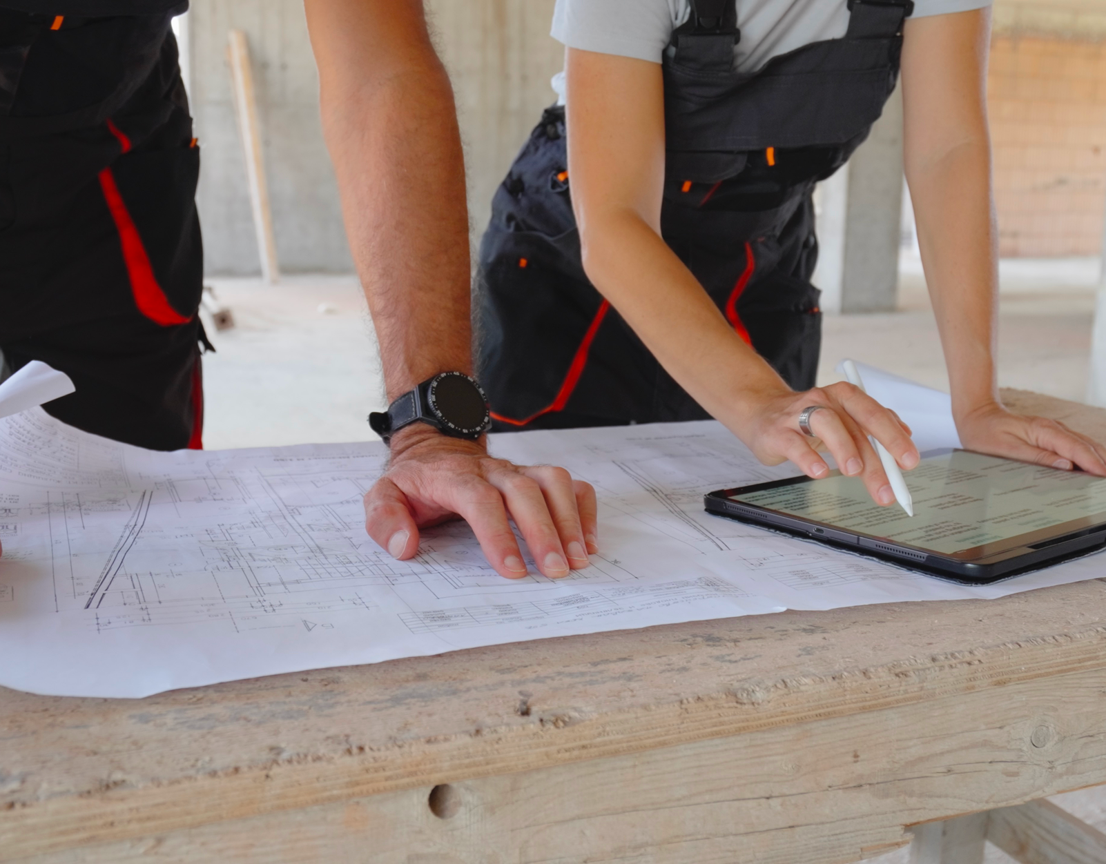 Engineers discussing building designs with technology
