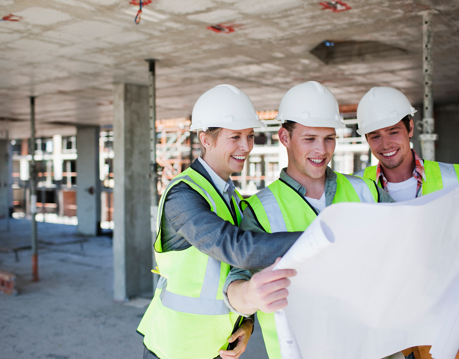 Construction workers reviewing blueprints