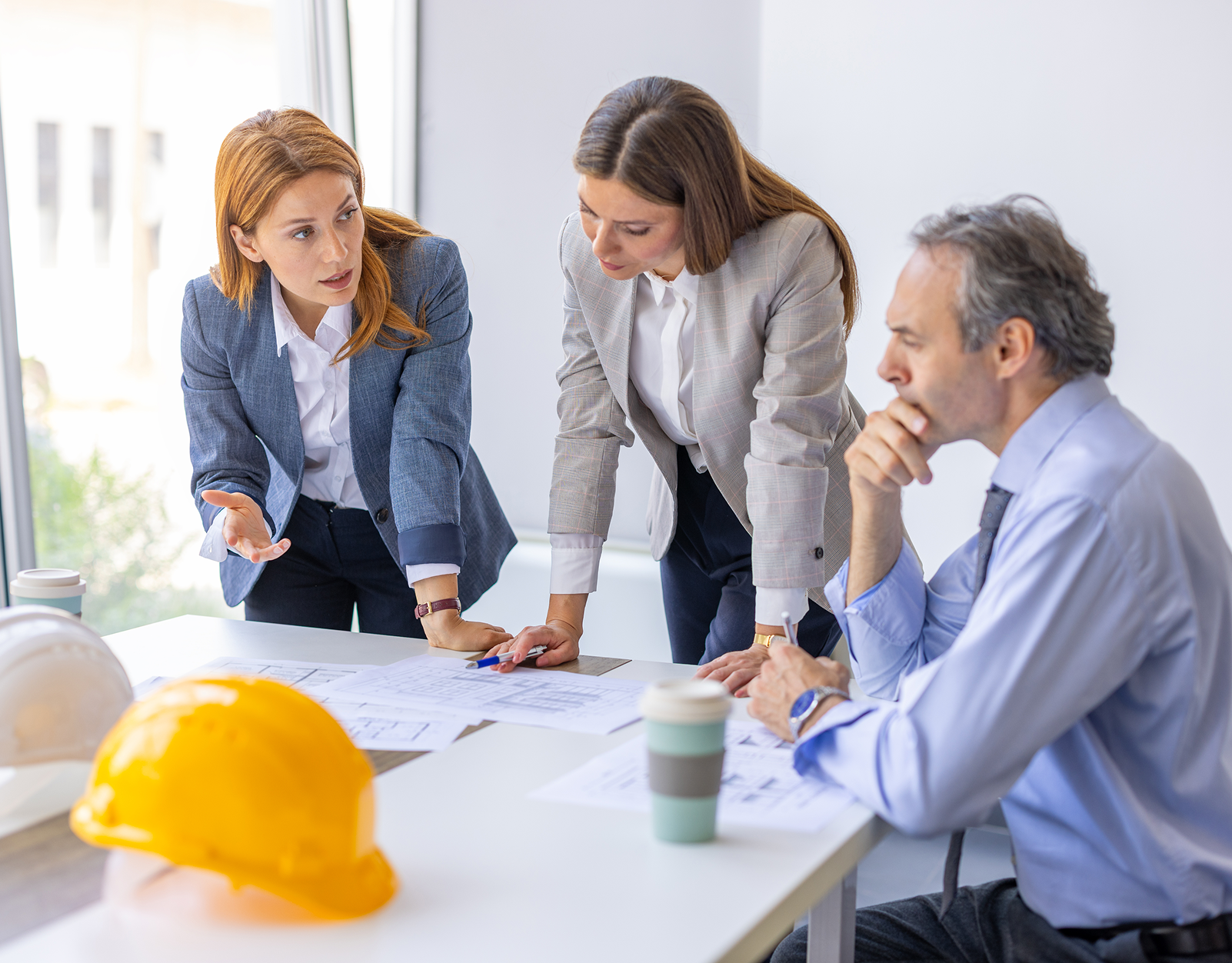 Professionals collaborating over architectural designs
