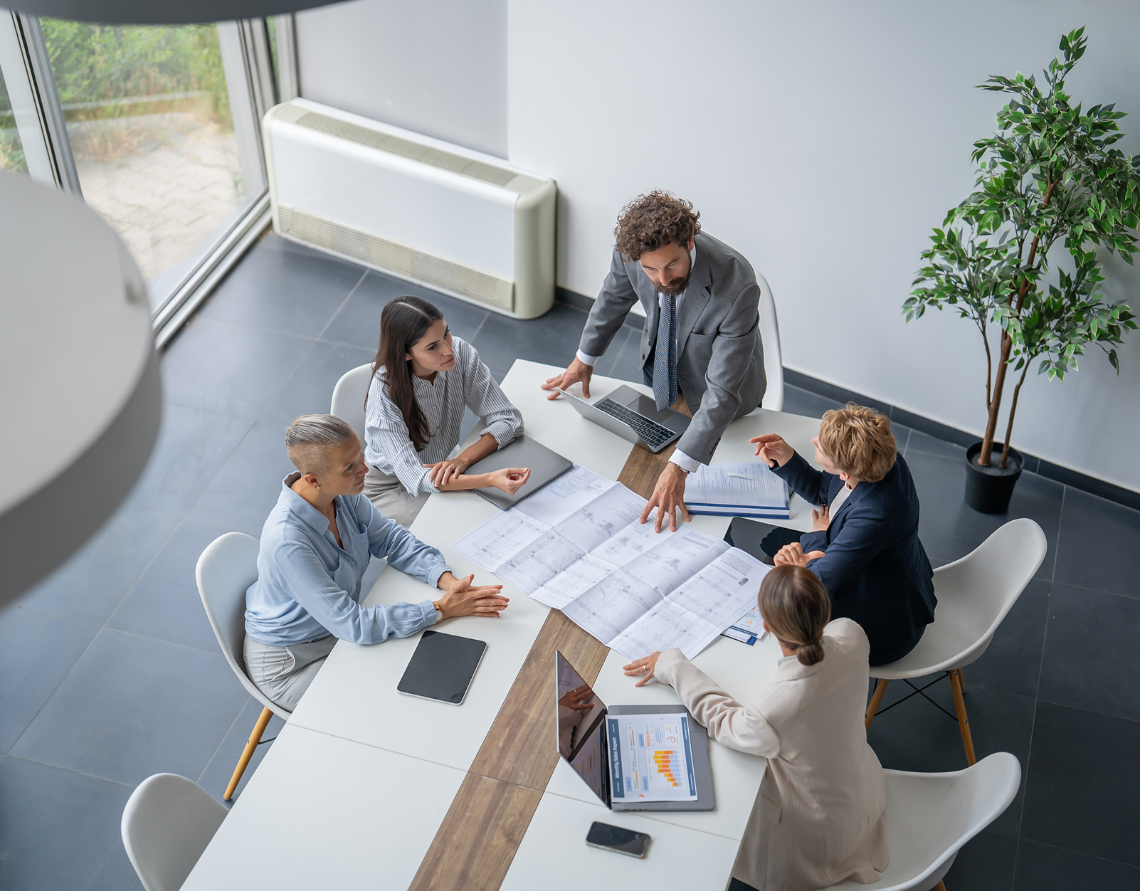 Group reviewing documents in conference room.