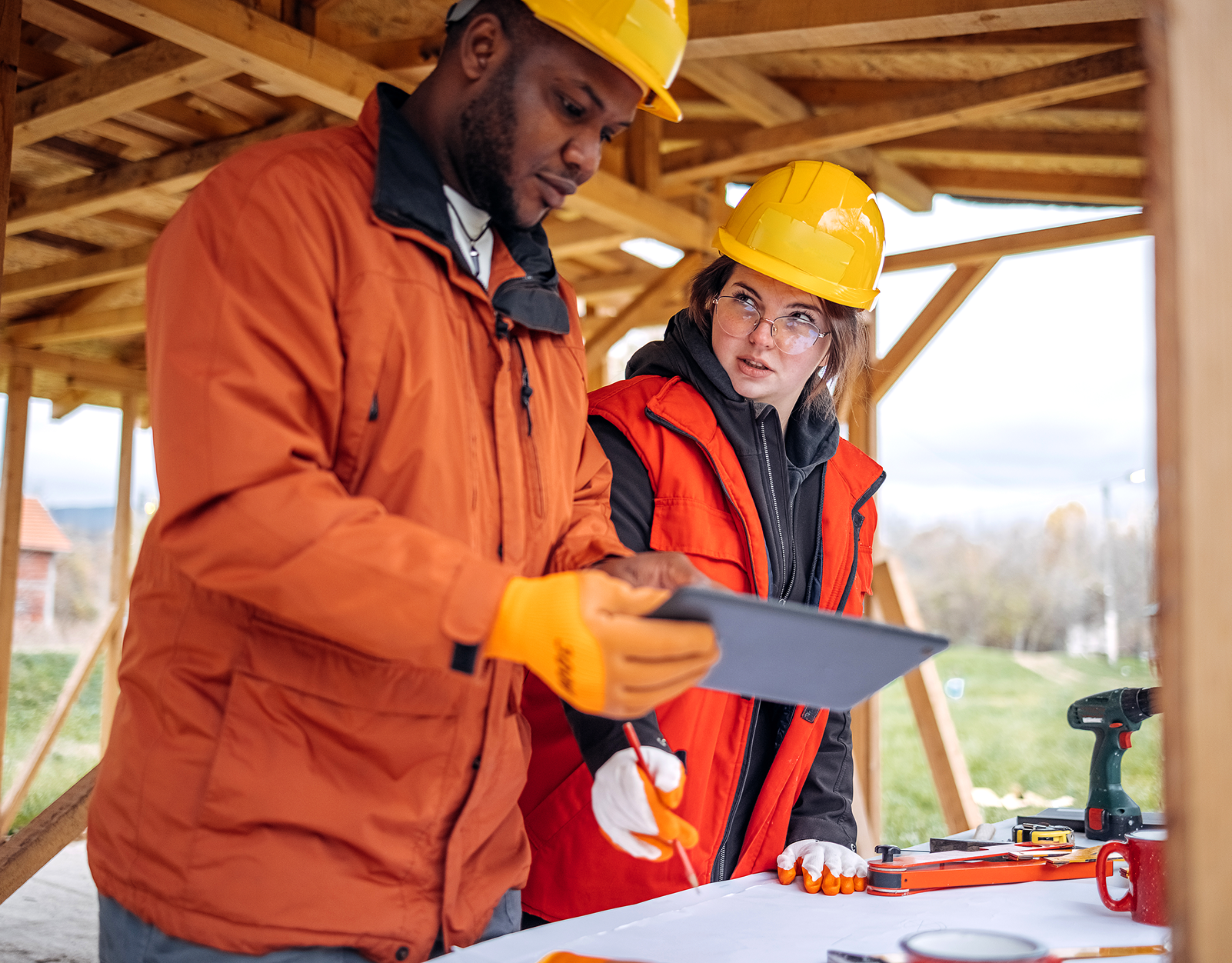 Construction workers reviewing plans outdoors